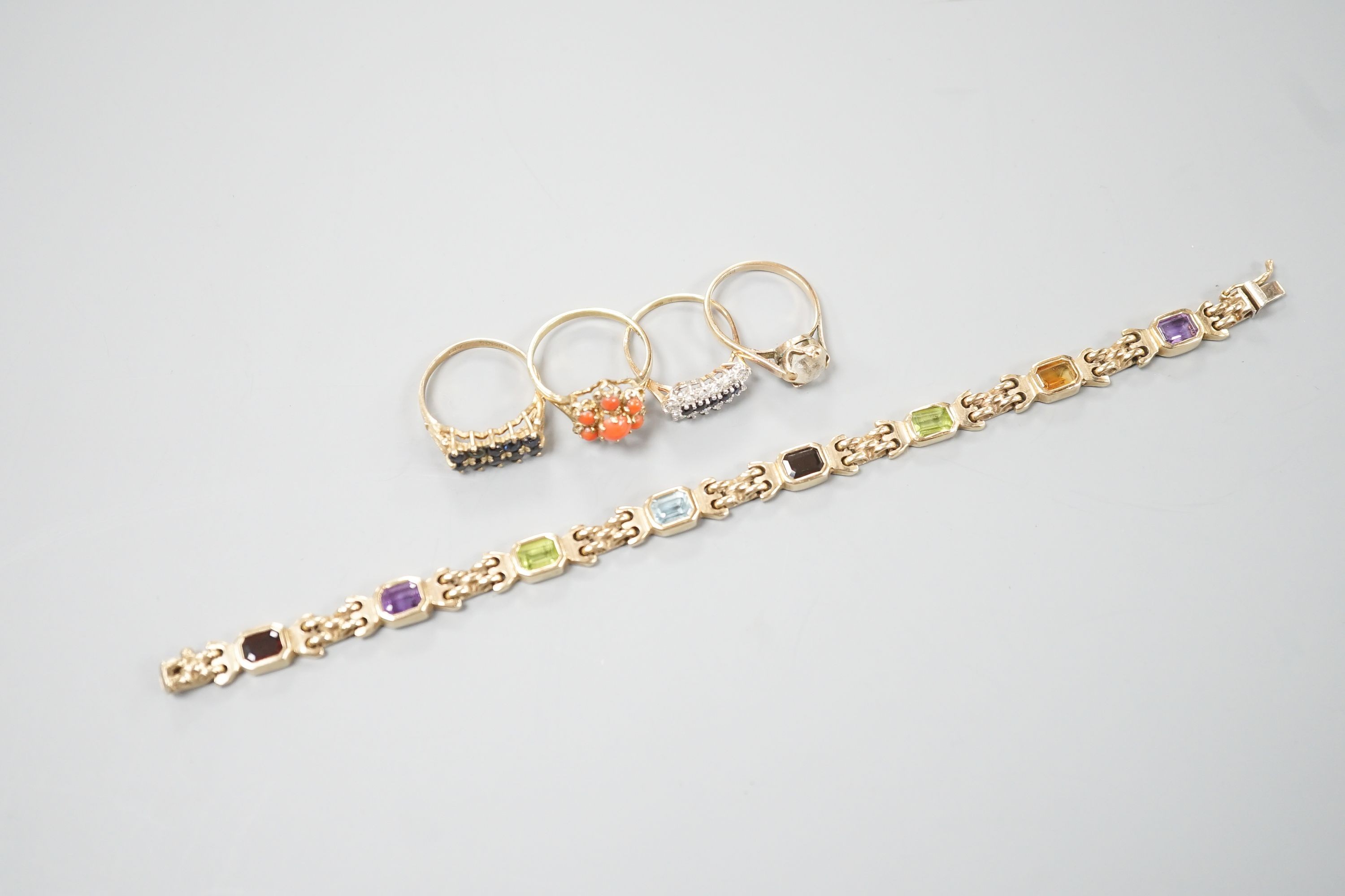 A modern 9ct gold and gem set bracelet and four assorted 9ct gold dress rings, gross 24.8 grams